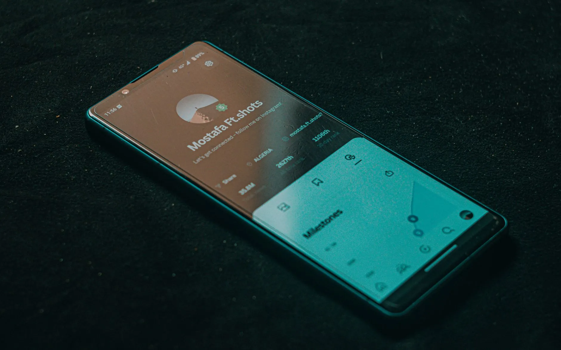 Smartphone displaying a mobile interface on a clean dark surface